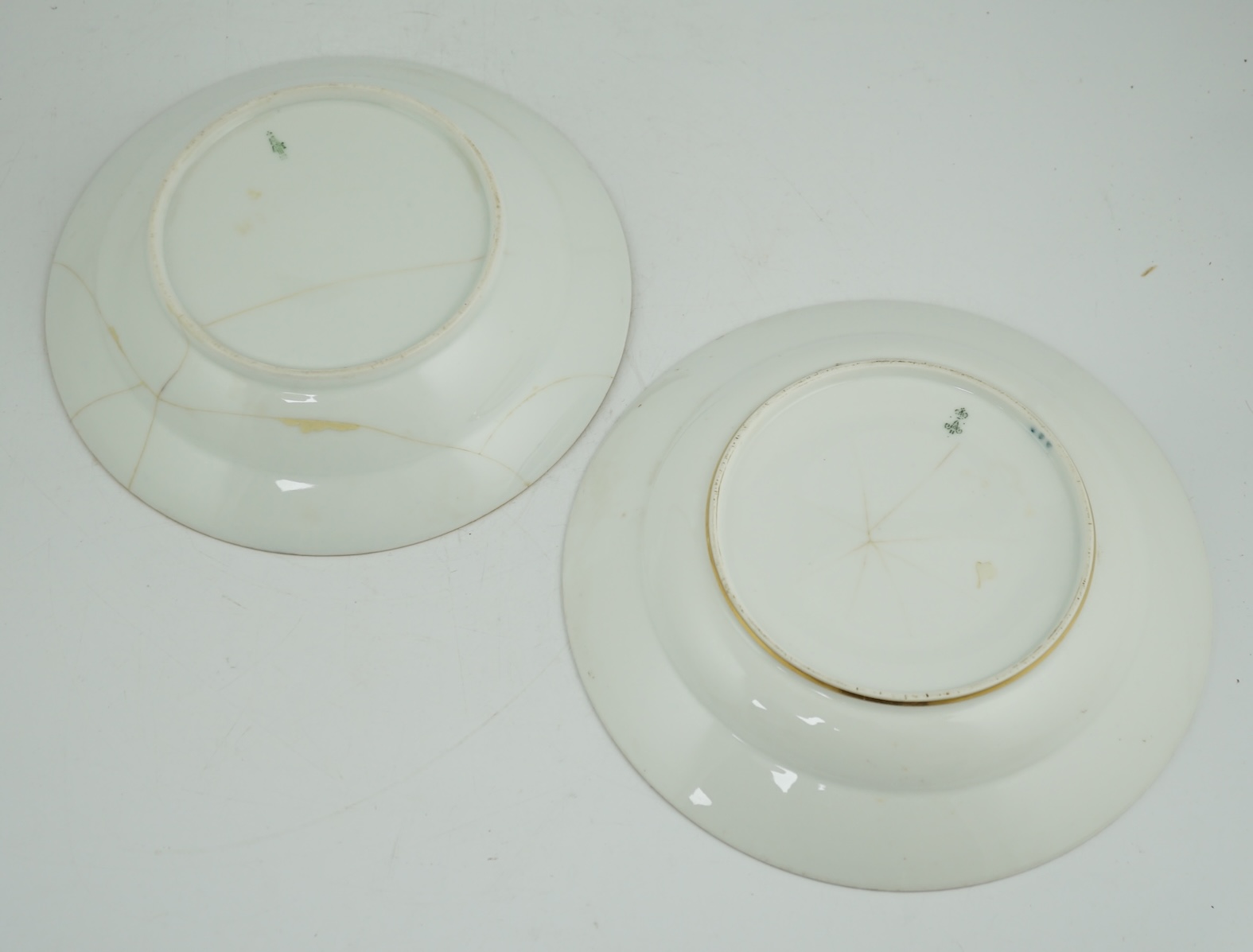 A pair of Nicholas II Imperial porcelain factory plates, from the Gothic service, green printed marks, 23.5cm diameter. Condition - poor to fair repairs